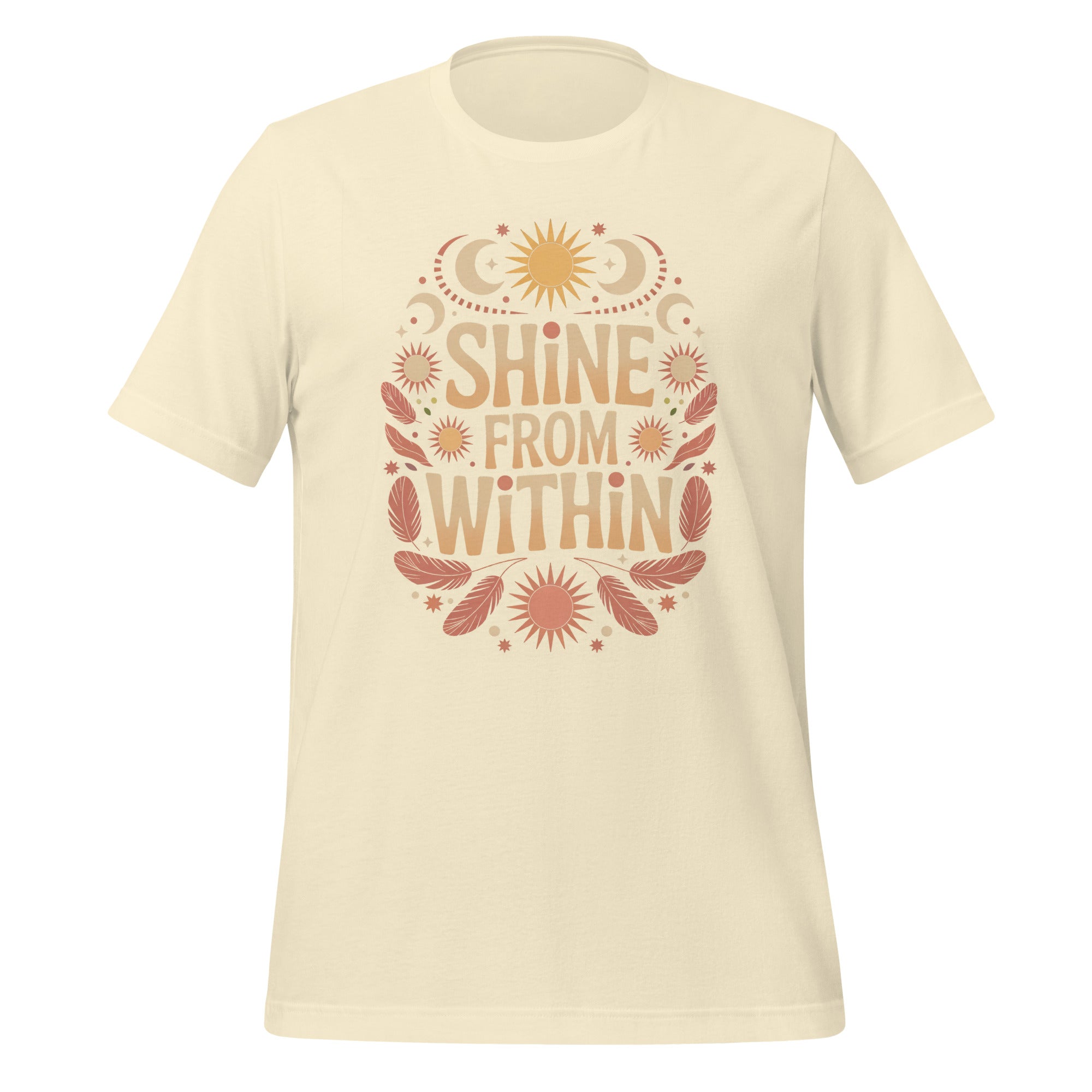 T-shirt unisexe avec un design positif affichant le texte "Shine From Within" (lettres orangées) entouré de motifs célestes (soleils, lunes, étoiles) et plumes beige et rose.