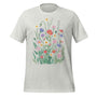 T-shirt unisexe gris clair avec un design vintage de fleurs sauvages (coquelicots, marguerites, chardons) en tons roses, violets, blancs, style bohème.