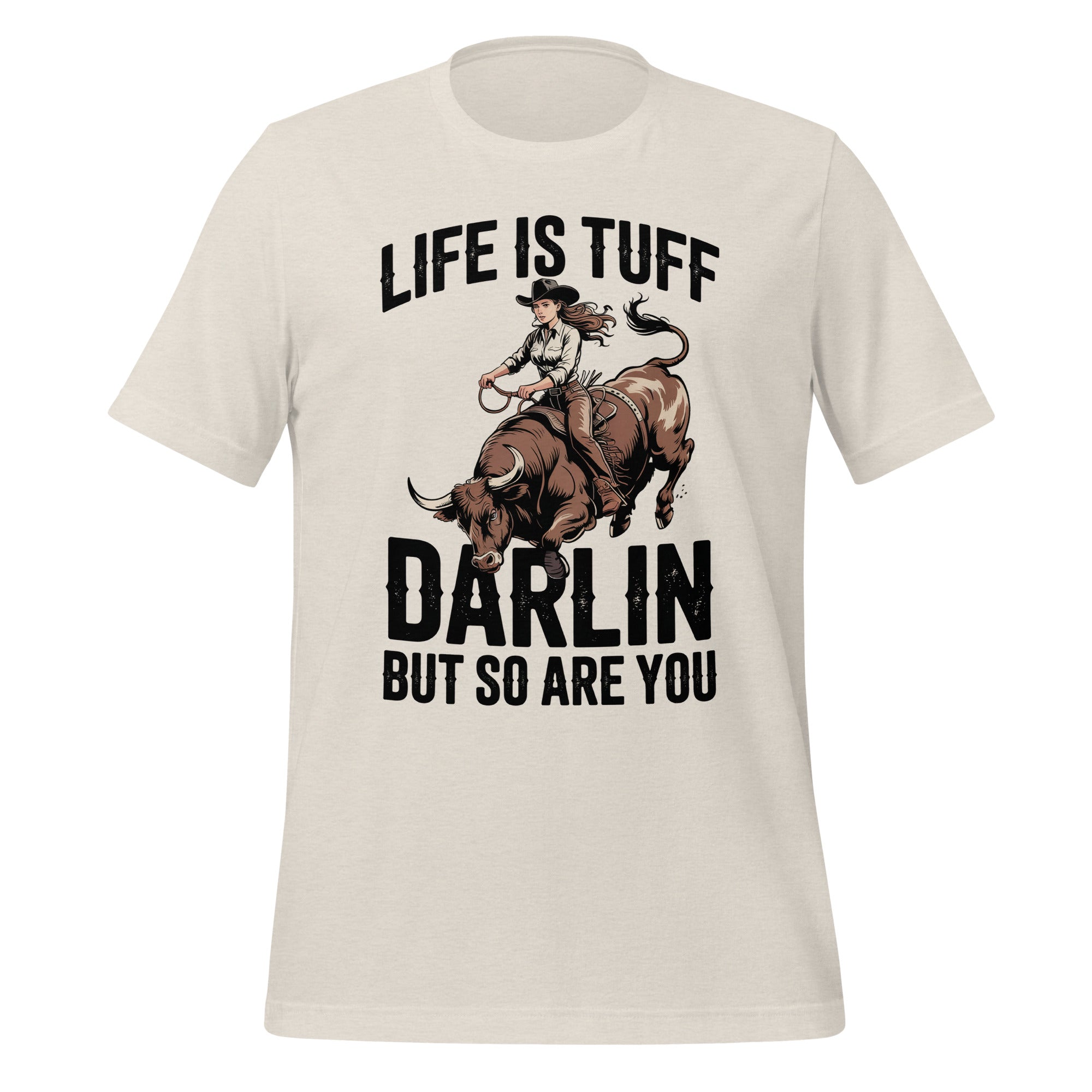 T-shirt unisexe beige avec un design western d’une cowgirl montant un taureau, texte "Life is Tuff Darlin but so are You", style robuste.