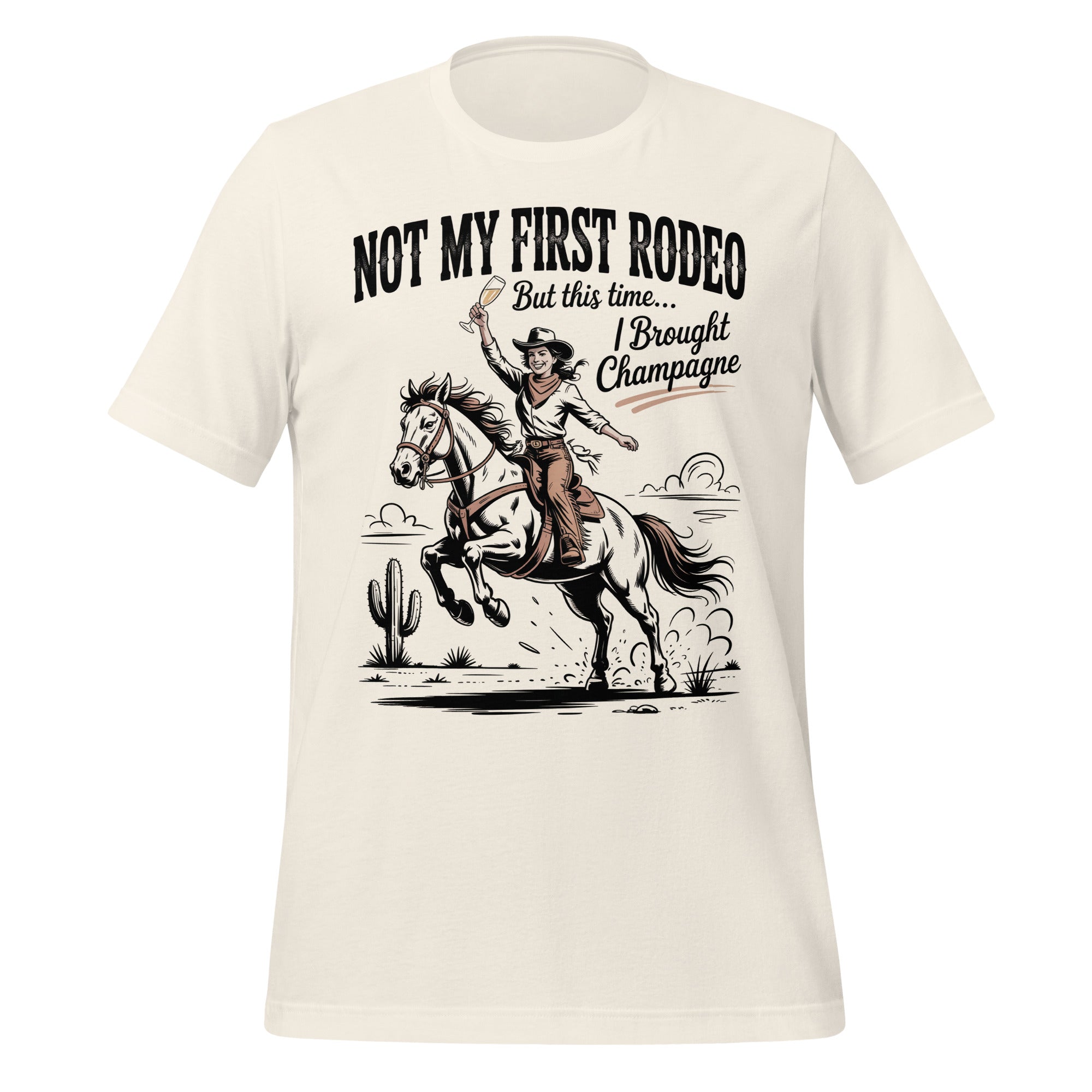 T-shirt unisexe blanc avec un design western "Not My First Rodeo", cowgirl à cheval avec champagne, style humoristique.
