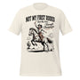 T-shirt unisexe blanc avec un design western "Not My First Rodeo", cowgirl à cheval avec champagne, style humoristique.