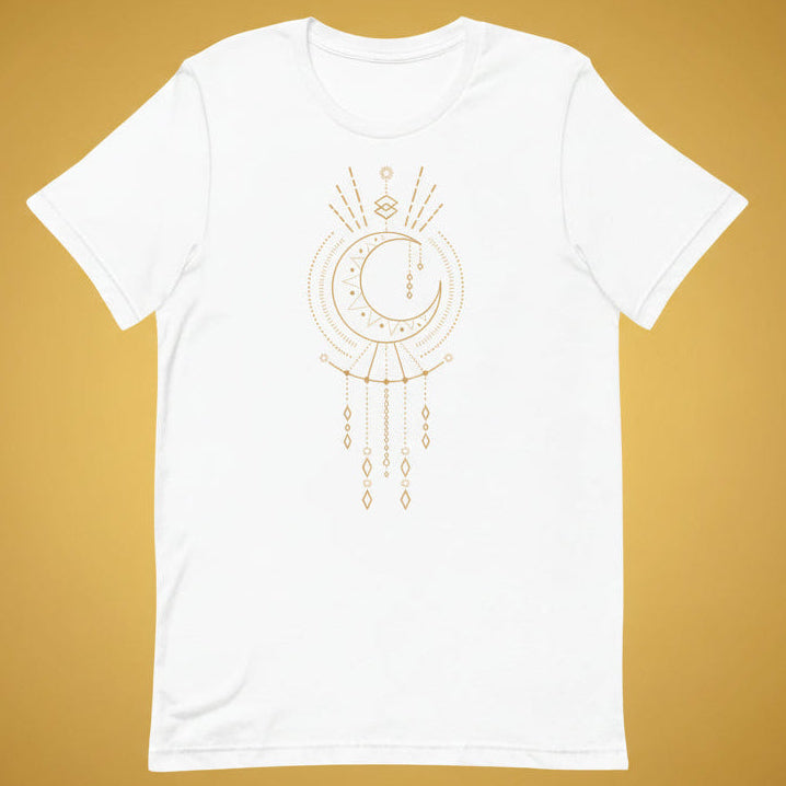 T-shirt blanc unisexe avec un design bohème d’une lune beige et dorée intégrée à un attrape-rêves avec des pendentifs en losanges, entourée de motifs géométriques comme des triangles et des rayons.